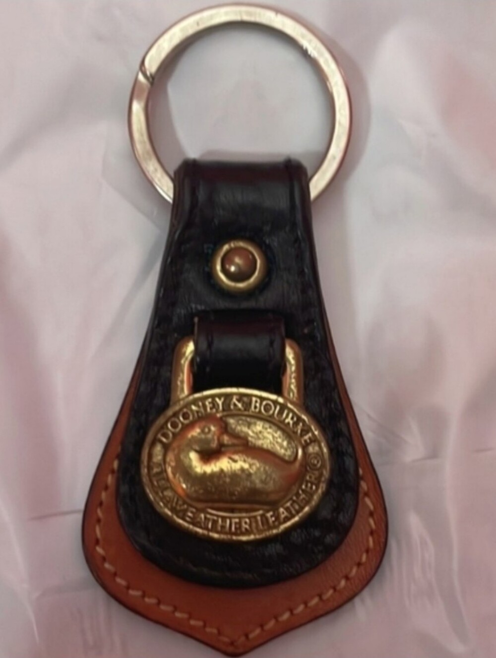 Dooney & Bourke Black and Tan Leather Key Holder with Brass Duck Medallion